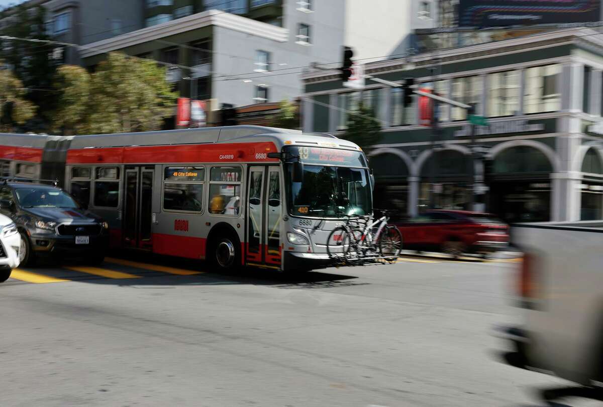 A Muni bus moves in the lane for the Bus Rapid Transit system on Van Ness Avenue in San Francisco.