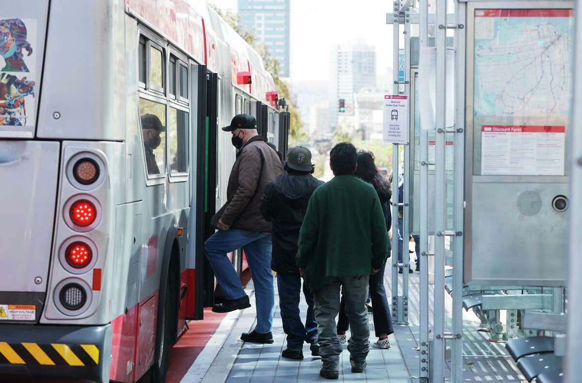 Riders board a Muni vehicle on the Bus Rapid Transit system, which the SFMTA says has cut travel times along Van Ness.