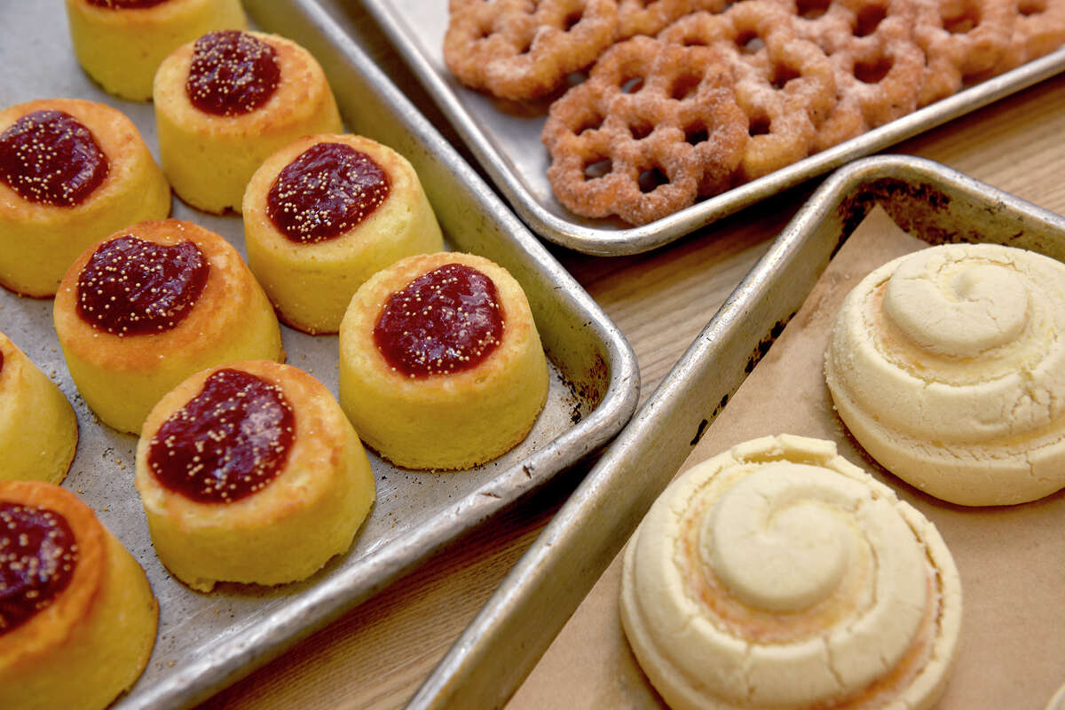 An assortment of Norte 54 pastries by local baker Raquel Goldman, clockwise from left: garibaldis with strawberry jam and amaranth, buñuelos (cinnamon sugar fritter) and vanilla conchas.