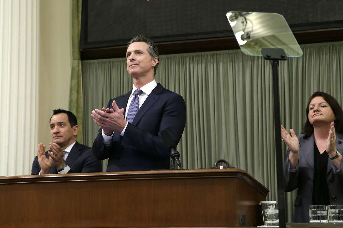 FILE - California Gov. Gavin Newsom, flanked by Assembly Speaker Anthony Rendon, left, and Senate President Pro Tempore Toni Atkins, right, applaud as introductions are made during Newsom's first State of the State address at the Capitol, on, Feb. 12, 2019, in Sacramento, Calif. California’s budget surplus has soared to a record $68 billion, Senate Democrats said Thursday, April 28, 2022, fueling a range of new spending proposals that include giving $8 billion back to taxpayers in the form of $200 checks. (AP Photo/Rich Pedroncelli, File)