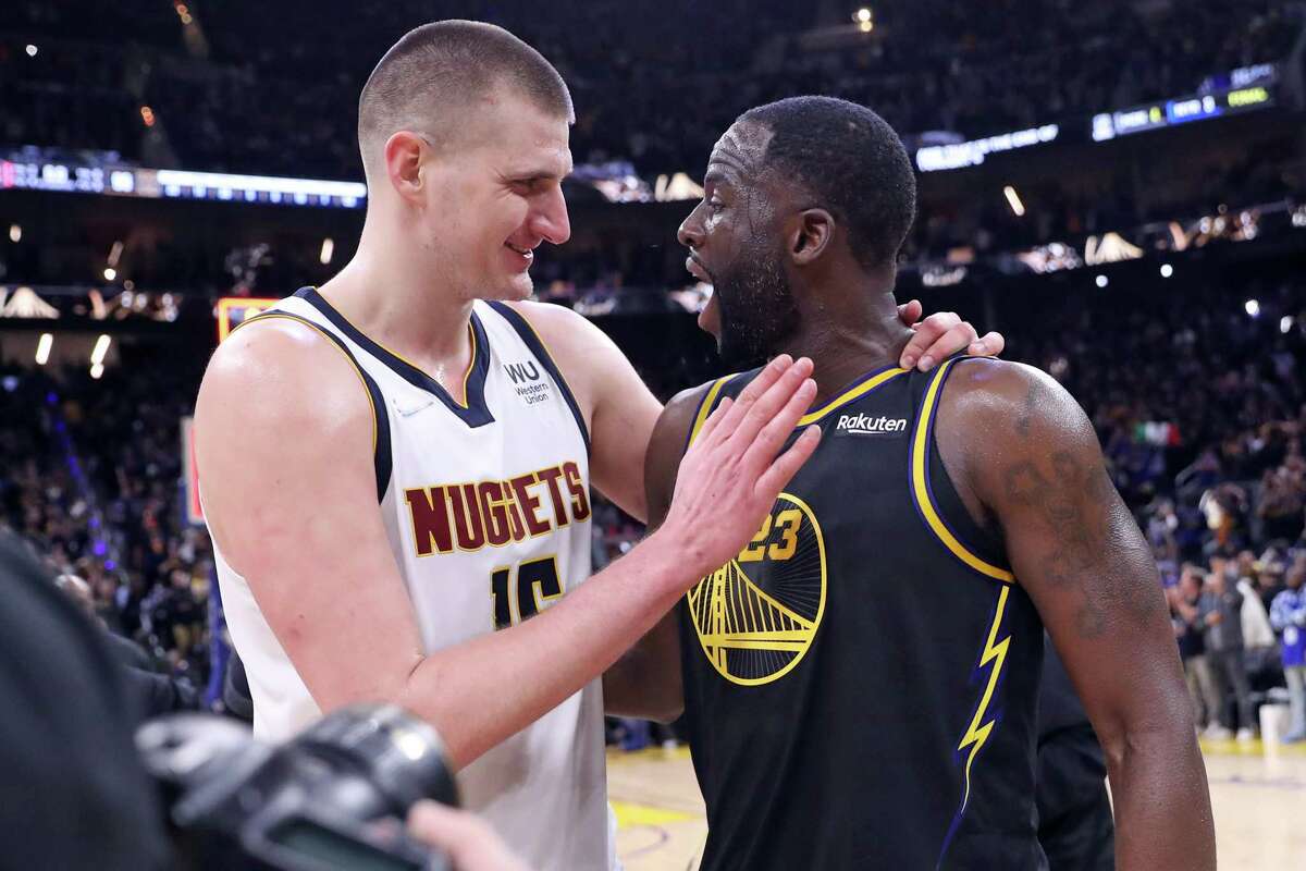 Golden State Warriors’ Draymond Green and Denver Nuggets’ Nikola Jokic greet each other after Warriors’ 102-98 win in Game 5 of NBA Western Conference First Round playoff game at Chase Center in San Francisco, Calif, on Wednesday, April 27, 2022.