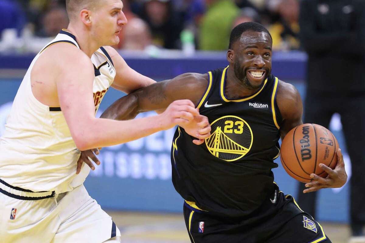 Golden State Warriors’ Draymond Green against Denver Nuggets’ Nikola Jokic during Warriors’ 102-98 win in Game 5 of NBA Western Conference First Round playoff game at Chase Center in San Francisco, Calif, on Wednesday, April 27, 2022.