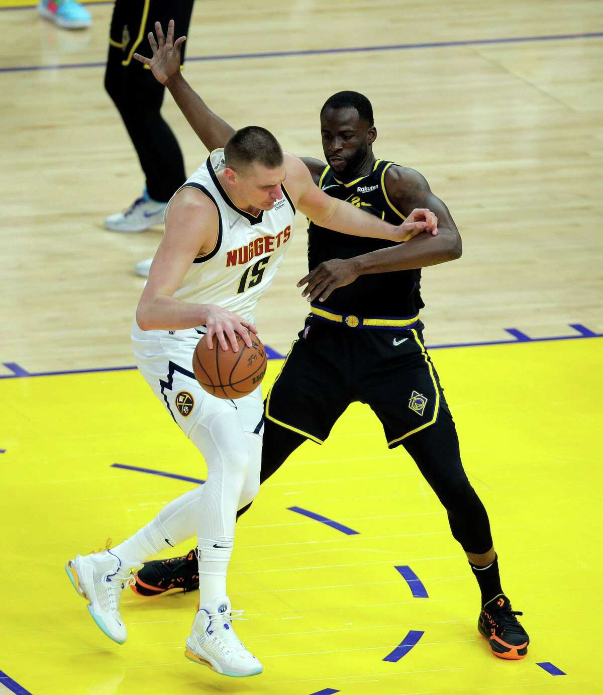 Draymond Green (23) defends against Nikola Jokic (15) as the Golden State Warriors played the Denver Nuggets in Game 5 of the first round of the NBA Playoffs at Chase Center in San Francisco, Calif., on Wednesday, April 27, 2022.