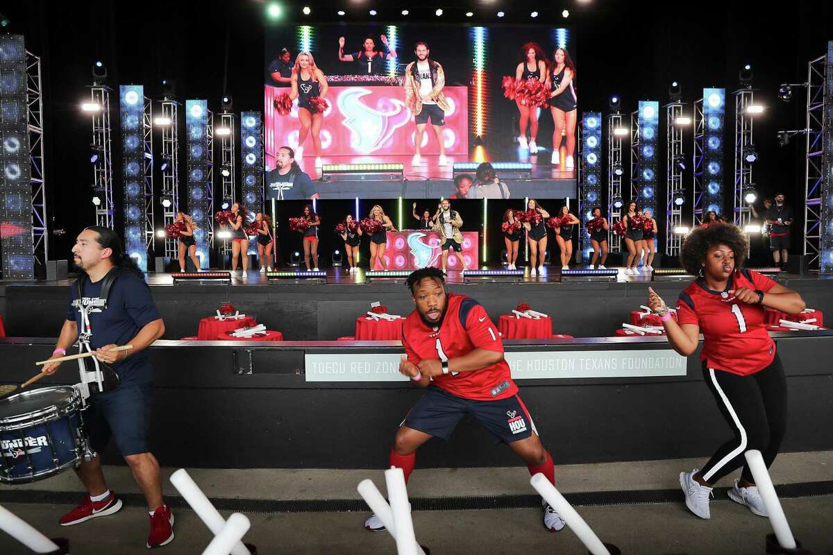 Dancer, drumers and Texans cheerleaders rehearse before an NFL draft party hosted by the Texans at Miller Amphitheater in Houston on Thursday, April 28, 2022.