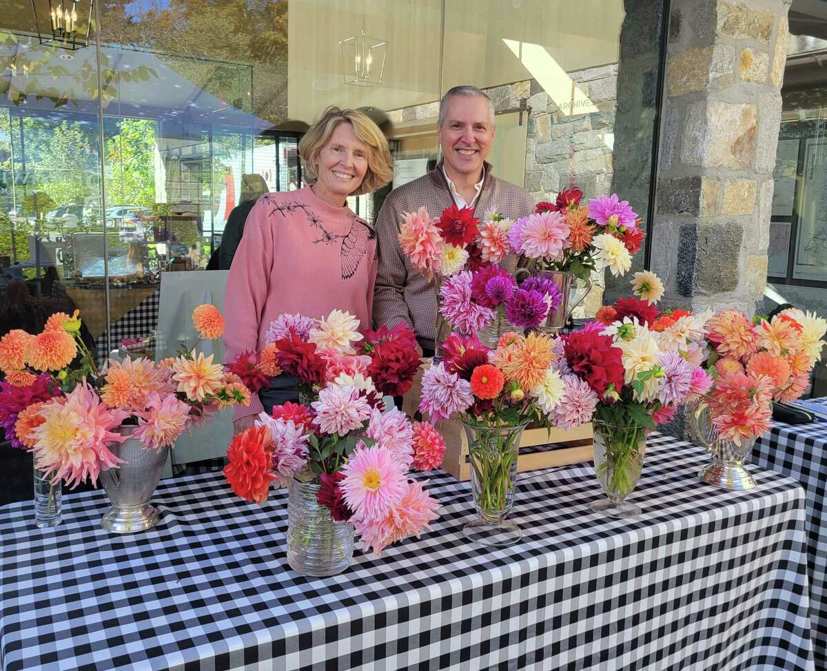 Anne T. Getz, of Tower Flowers, joined by the Greenwich Historical Society’s Daniel Suozzo, attracts attention at a Tavern Garden Market last year, with glorious Dahlias taken from her Greenwich garden and design studio.