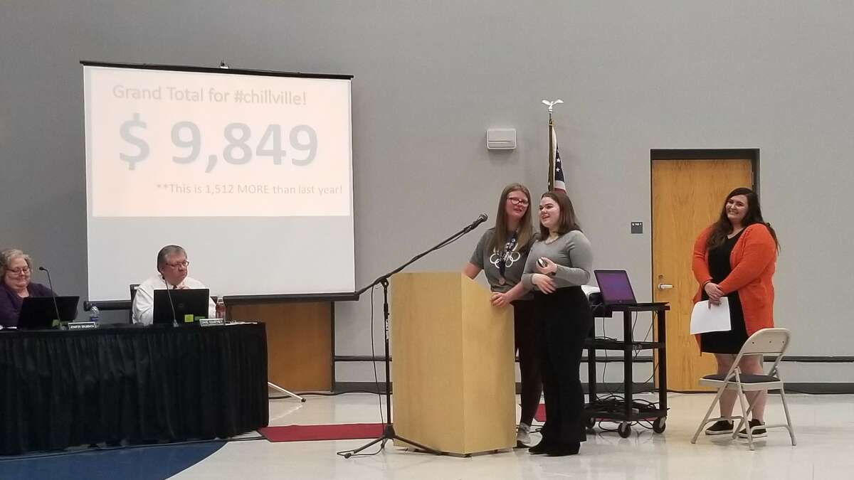 Ashlyn Porter and Ella Feldman announcing the Polar Plunge grand total with Special Olympics Athletic Director Kayla Magruder in the background. 