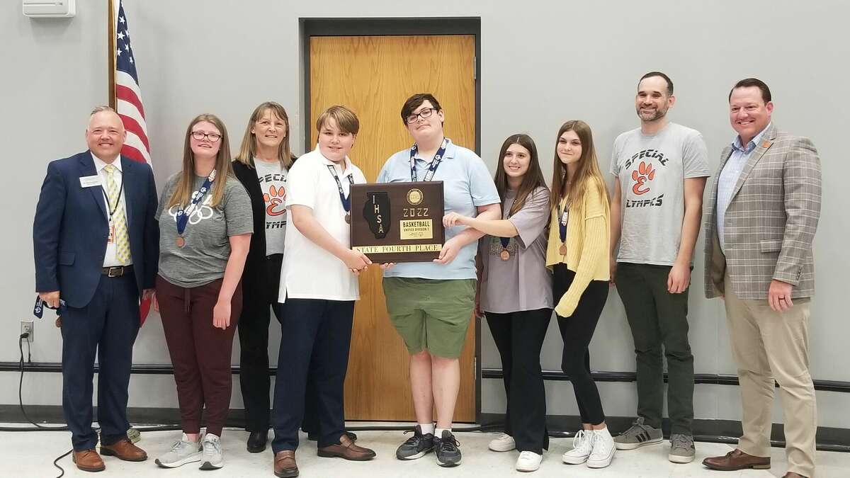 From left to right, Superintendent Patrick Shelton, Ashlyn Porter, Head Coach Yvonne Hallemann, Wesley, Derrek, Olivia, Lindsay, Assistant Coach Tim Leveling and Board President John McDole. Not pictured are players Brady, Kelly and Logan and Assistant Coach Kevin Watson. 
