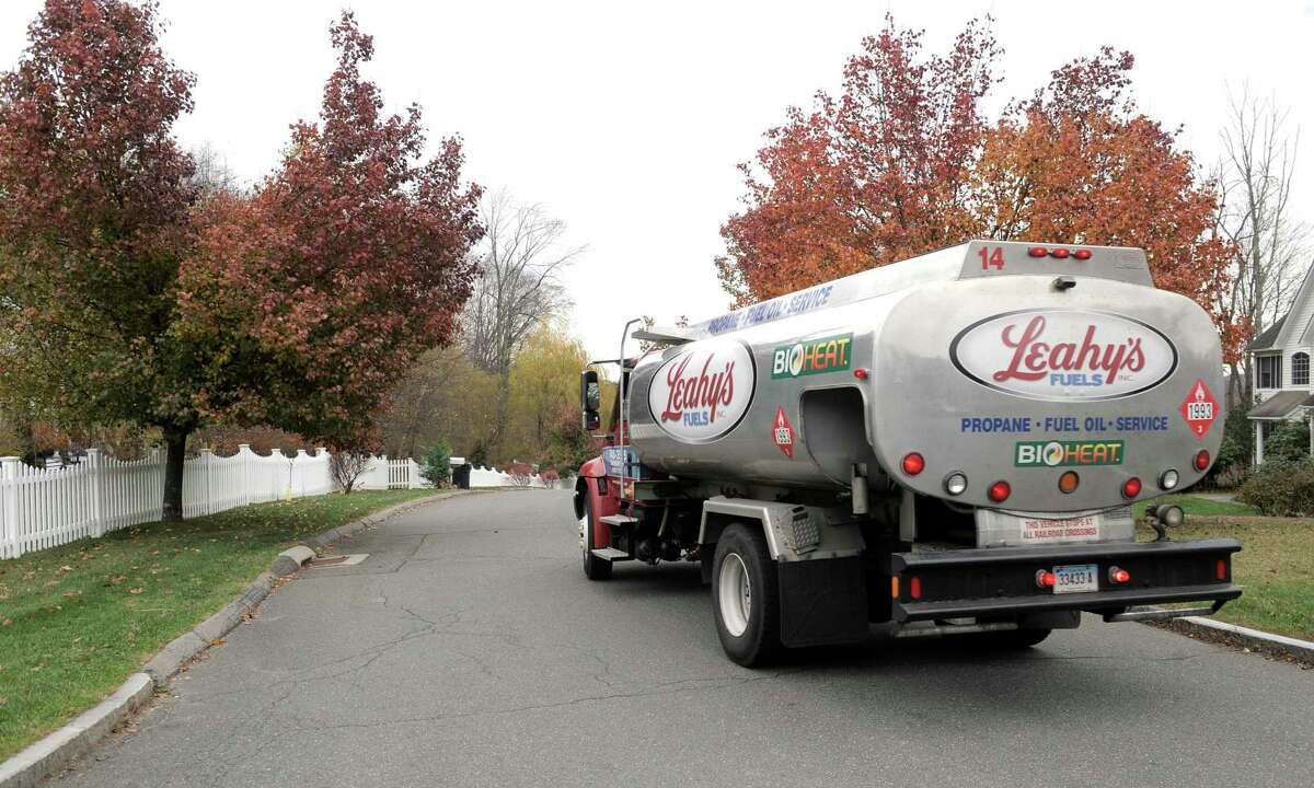 File photo— Leahy's Fuels oil delivery driver Eric Svege makes a home heating oil delivery to a Mariana Farms Drive home, in Danbury, Conn.