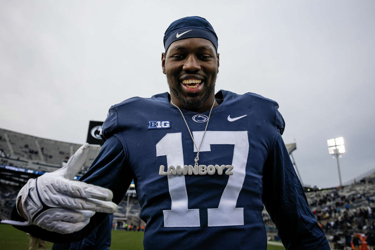 Arnold Ebiketie of the Penn State Nittany Lions celebrates while wearing the running backs chain after the game against the Rutgers Scarlet Knights at Beaver Stadium on November 20, 2021 in State College, Pennsylvania.