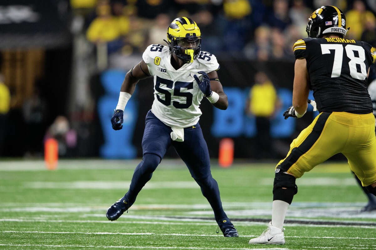 Michigan Wolverines linebacker David Ojabo (55) rushes into the backfield against Iowa Hawkeyes offensive lineman Mason Richman (78) during the Big 10 Championship game between the Michigan Wolverines and Iowa Hawkeyes on December 4, 2021, at Lucas Oil Stadium in Indianapolis, IN.
