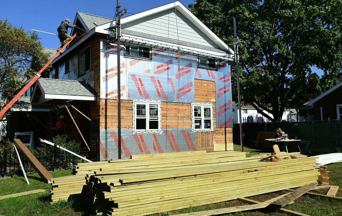 Construction workers renovate Colonial Village buildings in Norwalk in 2021.