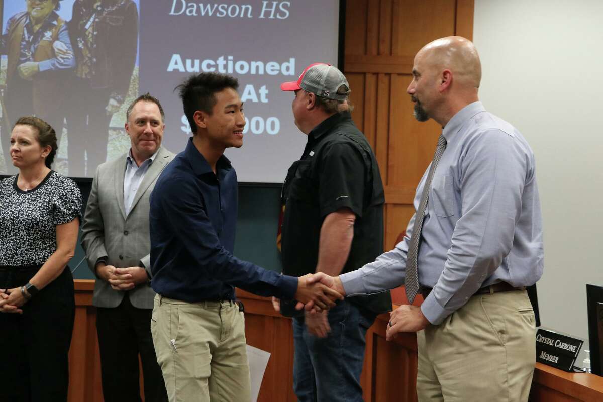 Pearland ISD Superintendent Larry Berger, right, is hosting parent forums at district junior high schools in October. With him is Dawson High School student Tanner Tran, whose art was displayed at the Houston Livestock Show and Rodeo.