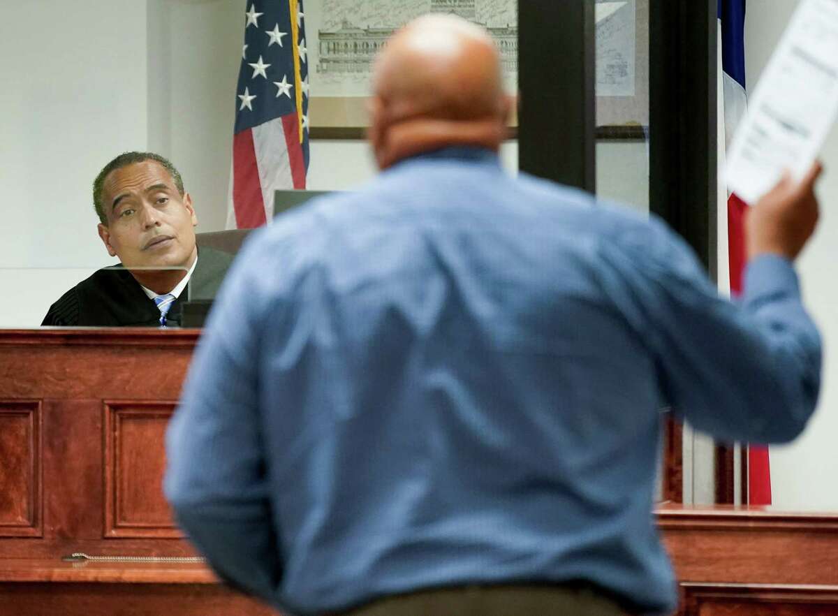 Judge Mark Gibson, left, hears debt lawsuit cases inside the Fort Bend County Justice of the Peace court on Tuesday, March 15, 2022, in Missouri City. The number of debt lawsuits being filed against Texans in civil justice courts has skyrocketed.