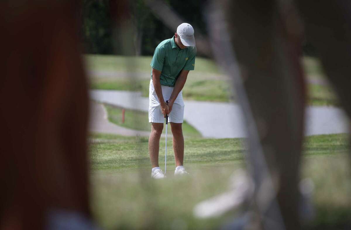 Andrew Ferworn putts on the 18th hole during the second round of the Region III-6A Boys Championship golf tournament Thursday, April 21, 2022, at Eagle Pointe Golf Club in Mont Belvieu.