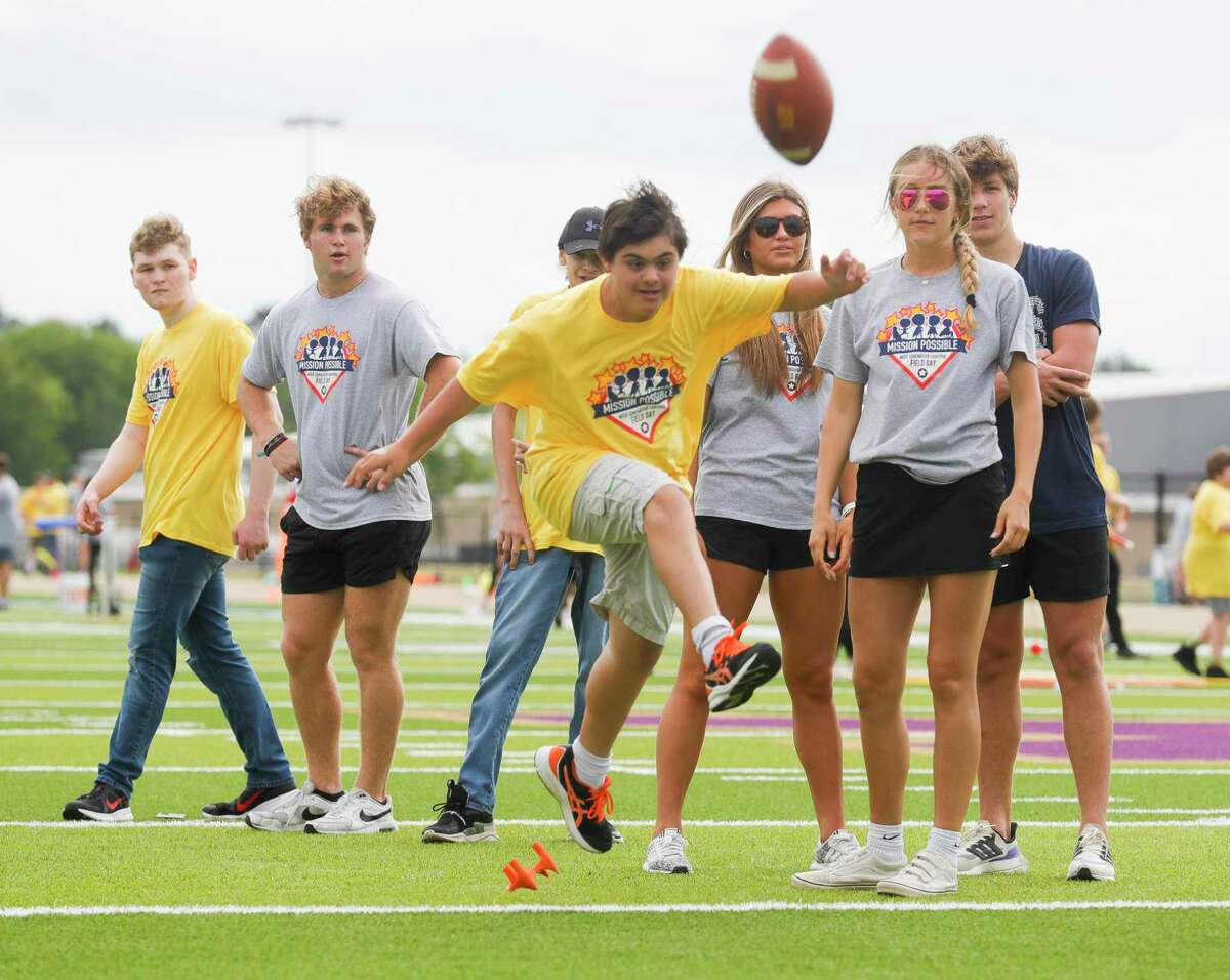 Matt Gomez kicks a field goal during Montgomery ISD’s annual Mission Possible Field Day for specialized learning students, Friday, April 29, 2022, in Montgomery. More than 150 students from across the district participated in modified activities including field games, track and field events and group games.
