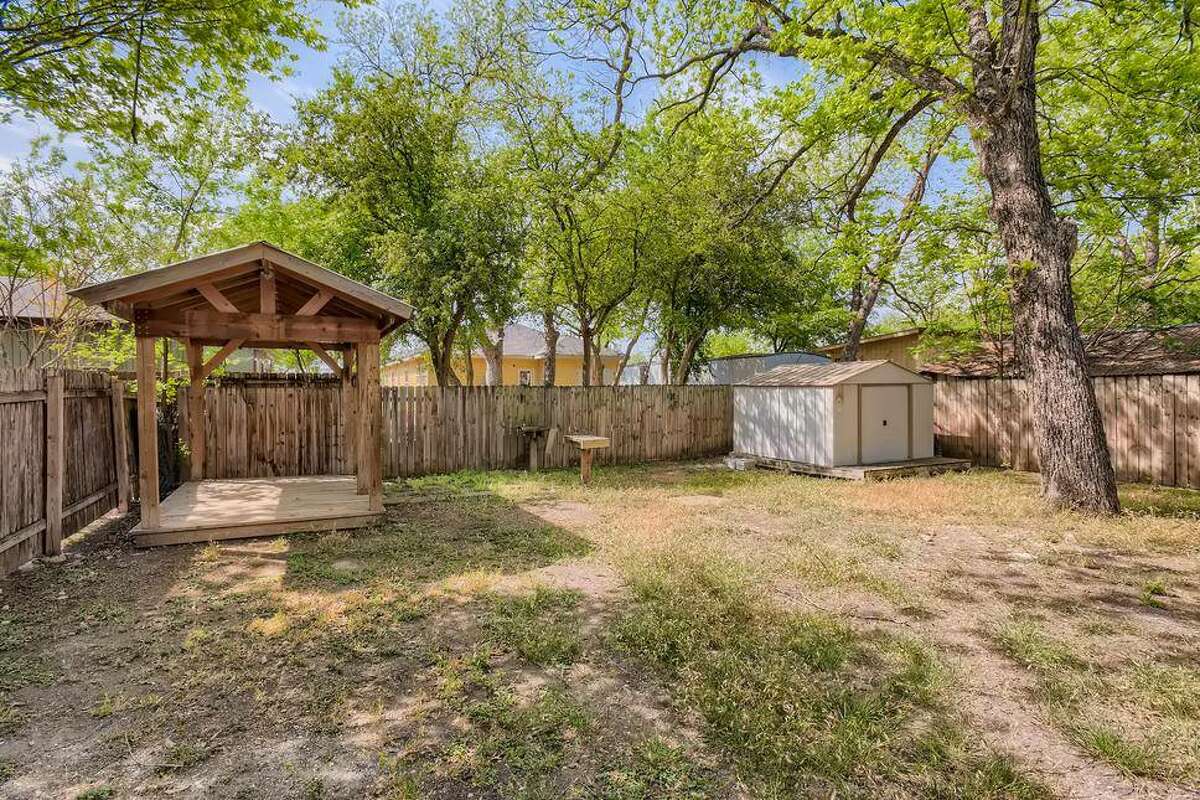 A small gazebo in the back makes this backyard nearly perfect.