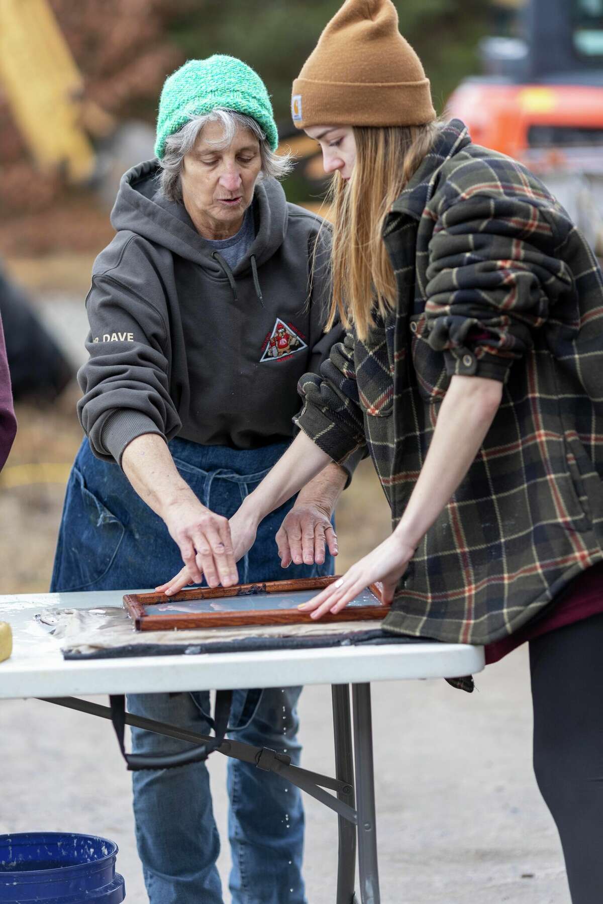 Artist Carol Vossler teaches student Annie McCandish of Lake Placid how to make sustainable paper during the natural resource science class at the Adirondack Educational Center in Saranac Lake in March. Photo by Mike Lynch
