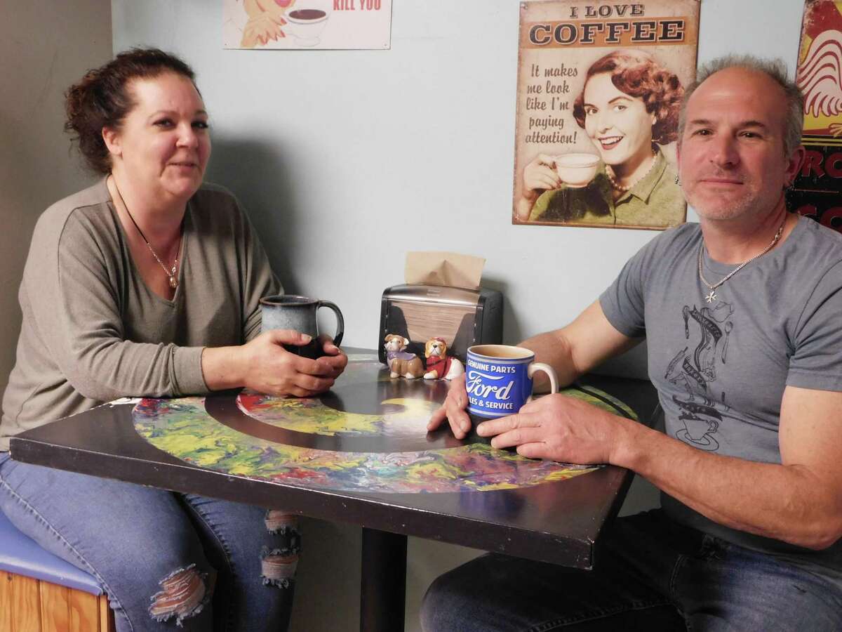 Love Hearts Bakery owners Allison Barker Croce and Ritchie Croce take a break at their bakery in Bantam.