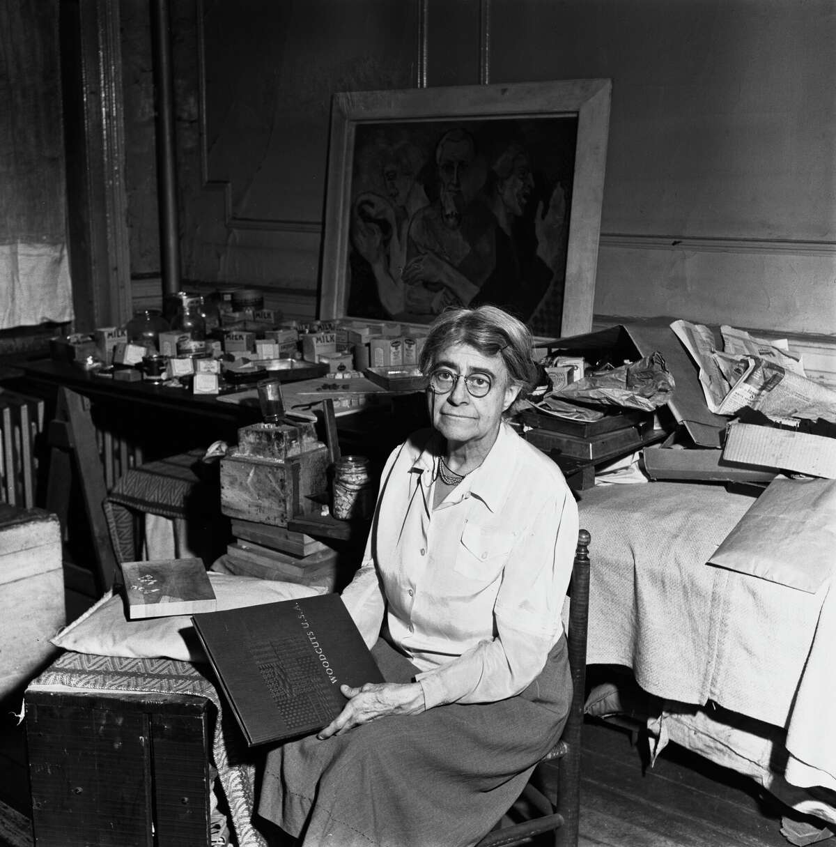 American painter and woodcut artist Helen West Heller with the book "Woodcuts USA," a collection of her works.