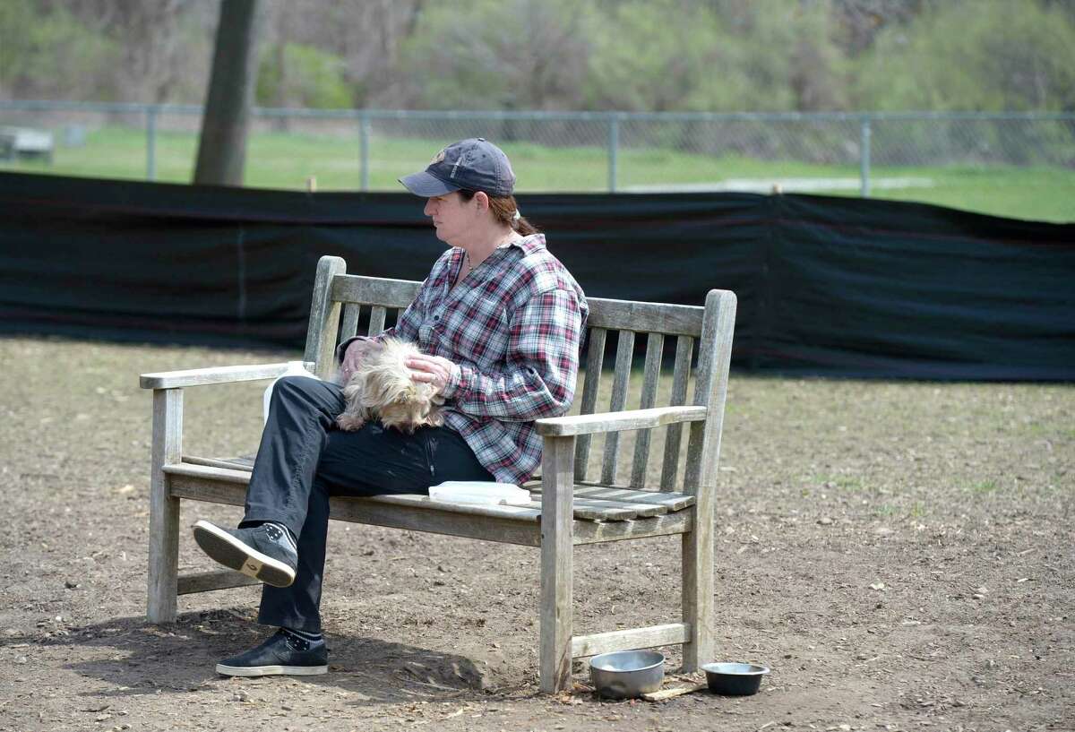 Amy Greene, of Sherman, sits with Manny in the Candlewoof Dog Park, on Monday. The park, the only dog park in New Milford, is run by volunteers. Monday, April 25, 2022, New Milford, Conn.