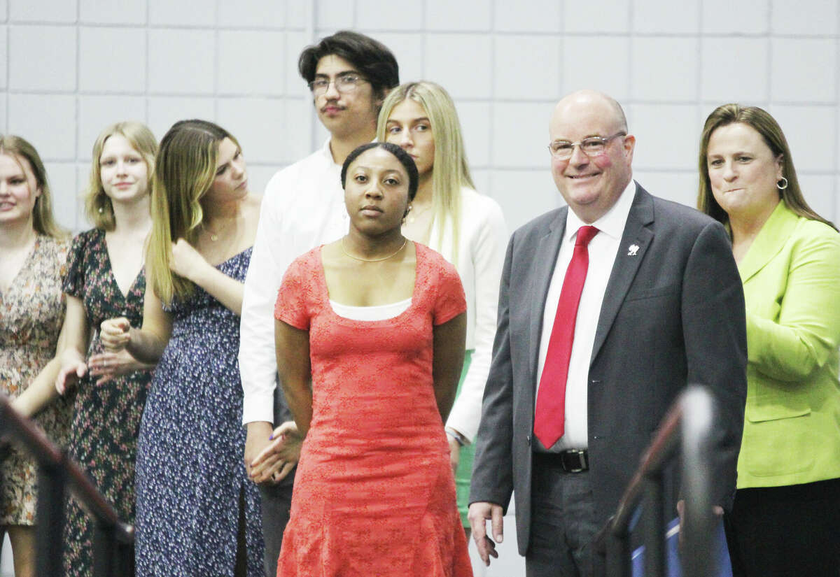 Alton High School students and administrators wait to go onstage at the Silver Medallion Academic Excellence Banquet, held at Lewis and Clark Community College. The award recognizes the top 8 percent of the graduating classes of 21 area high schools, as well as a male and female scholar athlete and teacher of the year. A total of 223 students, including 45 from AHS, received medallions this year.