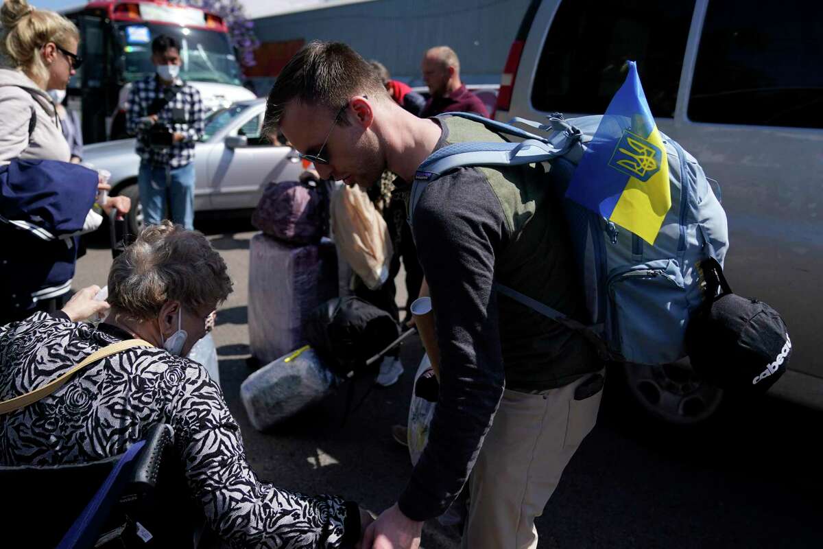 A group of Ukrainians arrive to a shelter Thursday, April 21, 2022, in the border city of Tijuana, Mexico. The Biden administration is making it easier for refugees fleeing Russia's war on Ukraine to come to the United States from Europe while trying to shut down an informal route through northern Mexico that has emerged in recent weeks. (AP Photo/Gregory Bull)