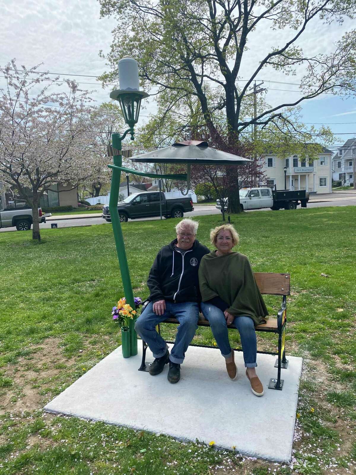 Sitting In The Shade is a new and artistic take on the traditional bench meant as an art project commissioned by the MAC. Pictured are bench creator Sonny Cardinali, left, and Paige Miglio, Milford Arts Council executive director.