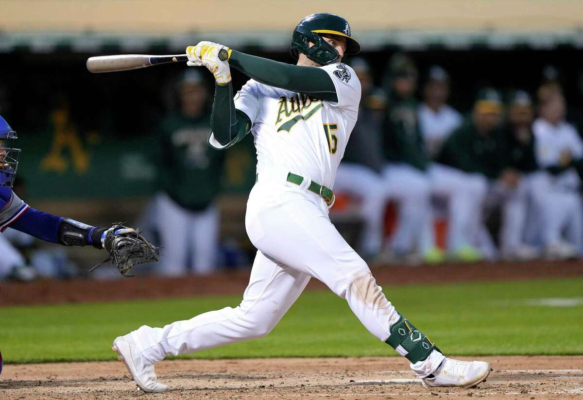 OAKLAND, CALIFORNIA - APRIL 22: Seth Brown #15 of the Oakland Athletics hits an RBI double scoring Sean Murphy #12 against the Texas Rangers in the bottom of the fourth inning at RingCentral Coliseum on April 22, 2022 in Oakland, California. (Photo by Thearon W. Henderson/Getty Images)
