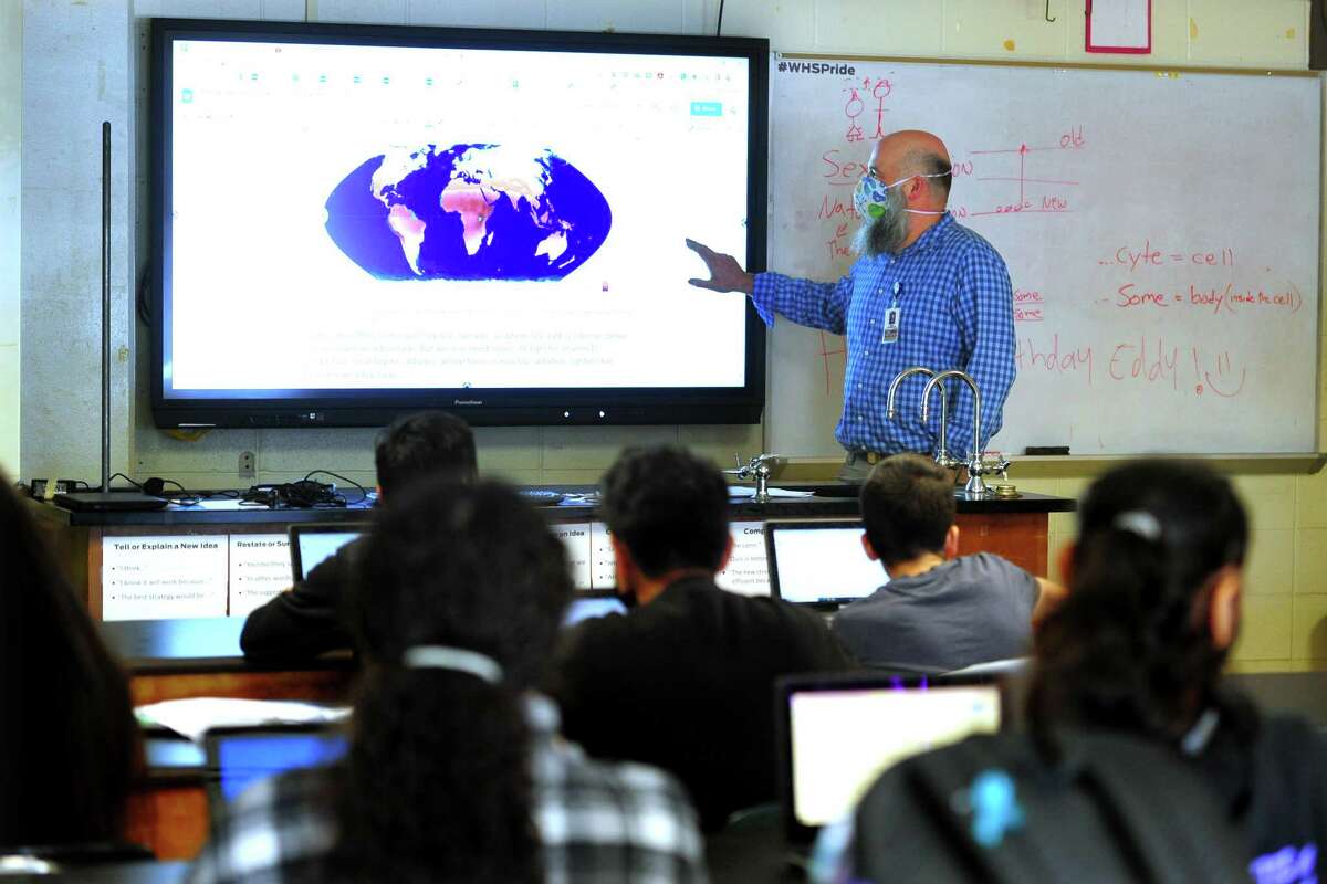 Westhill High School teacher Sean Otterspoor teaches a science class at the school in Stamford, Conn., on Friday April 22, 2022. At the school, teachers like Otterspoor is taking part in a pilot program called Grading for Equity. The biggest change they implemented was a shift from the traditional 1-100 grading scale.