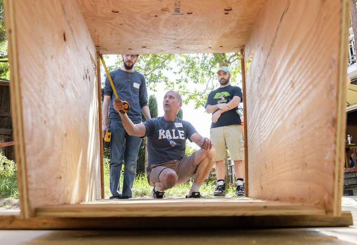 NASA engineer Jay Samson takes the measurements of a mobile plywood shelter he and his fellow volunteers are building to offer to an unhoused person in San Jose. Samson's grassroots effort, called Simply Shelter, was inspired by a Santa Cruz climate activist and the increased visibility of homelessness during the pandemic.