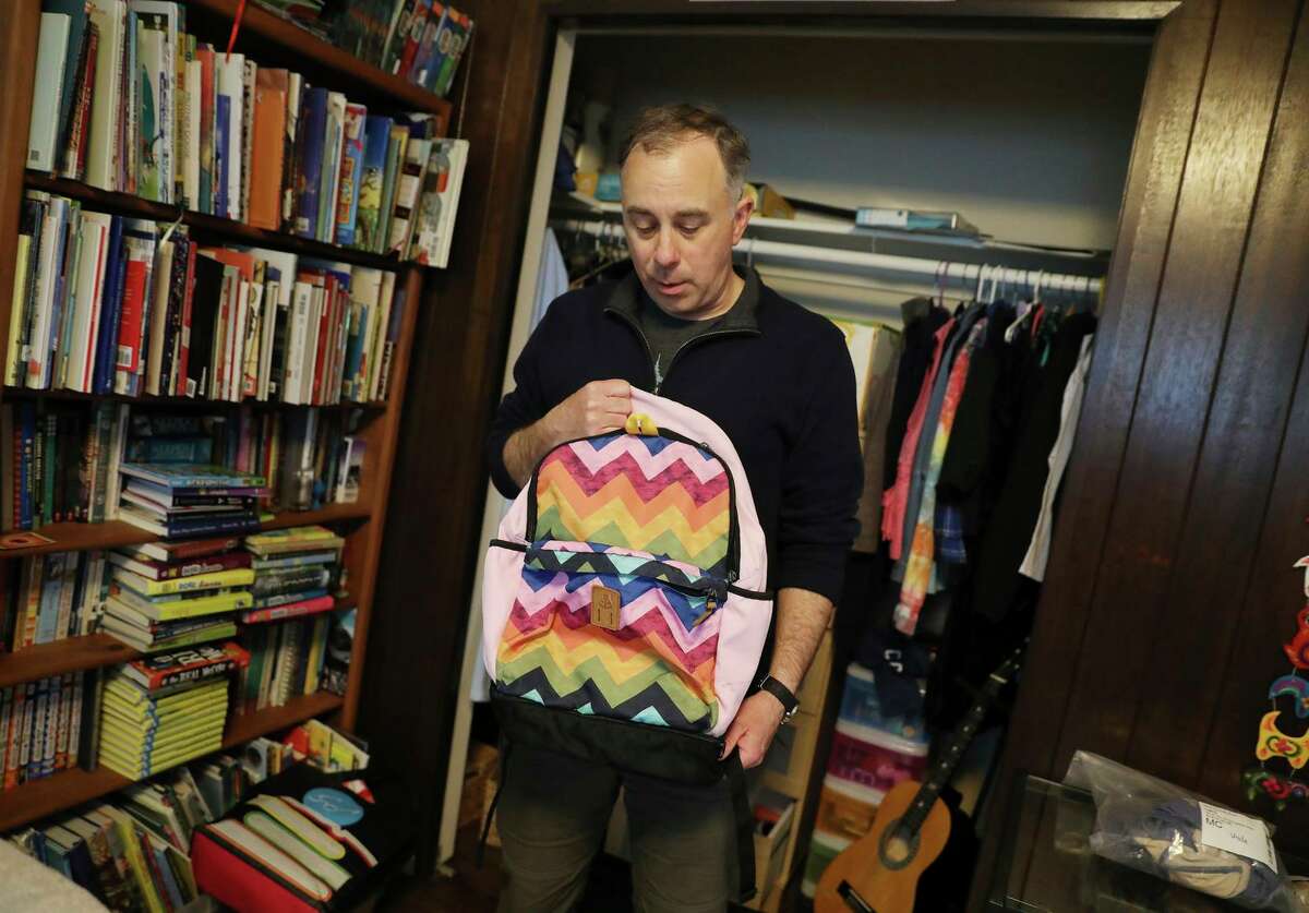 Tyler Sterkel, who lives in San Francisco’s Miraloma Park neighborhood, displays a backpack belonging to his daughter that he recovered after it was stolen while he was packing his car for a family road trip.