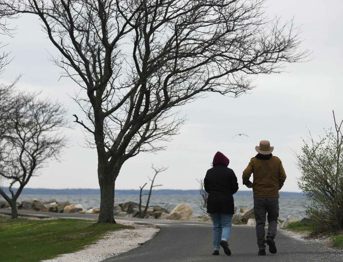 Folks walk the scenic loop around Greenwich Point Park in Old Greenwich, Conn. Thursday, April 21, 2022. Greenwich Point will be restricting itself to pass holders only starting May 1.