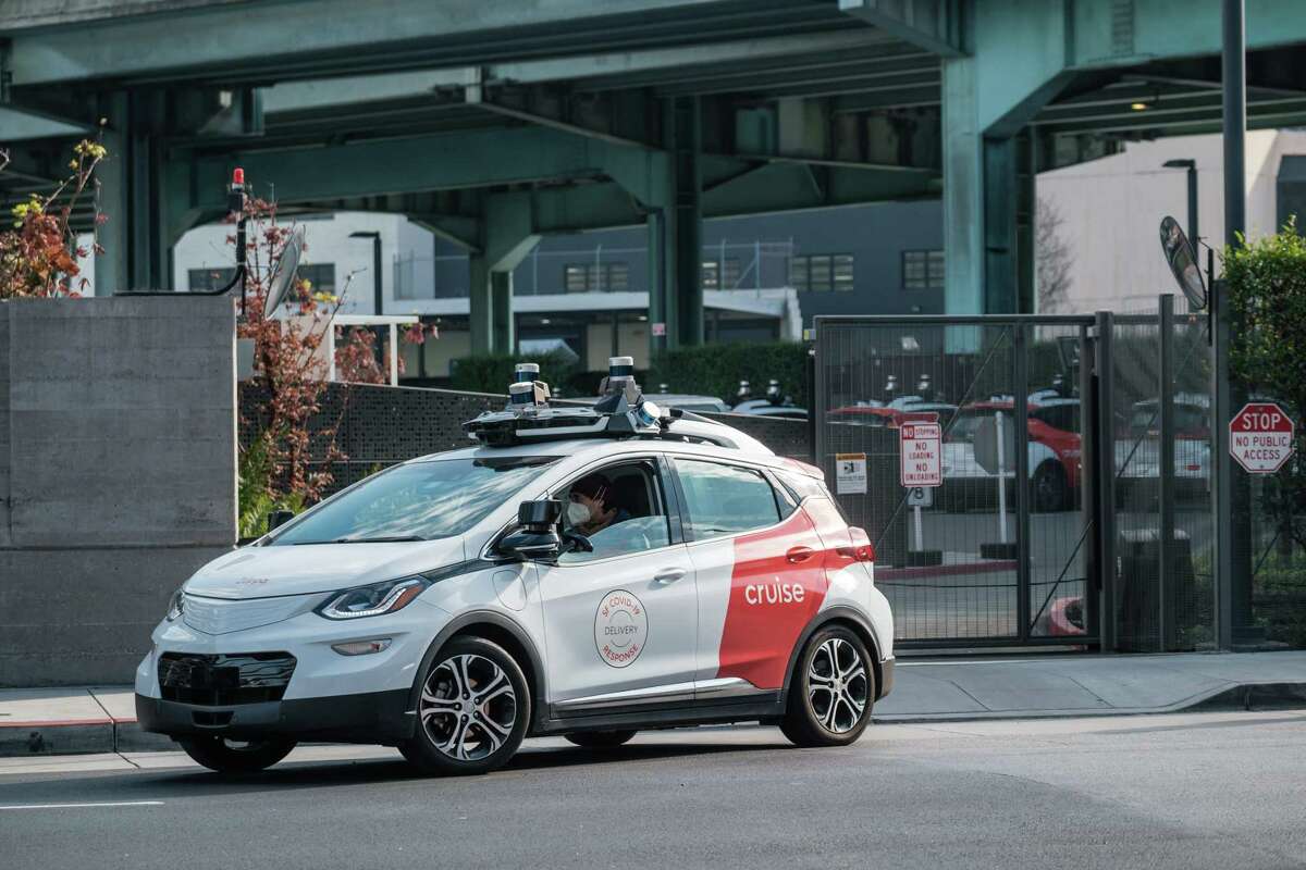 .A Cruise vehicle, with driver, is seen exiting the company parking lot in San Francisco on Wednesday, December 9, 2020. Cruise could soon become the first company to offer paid robot-taxi rides in San Francisco without a backup driver.