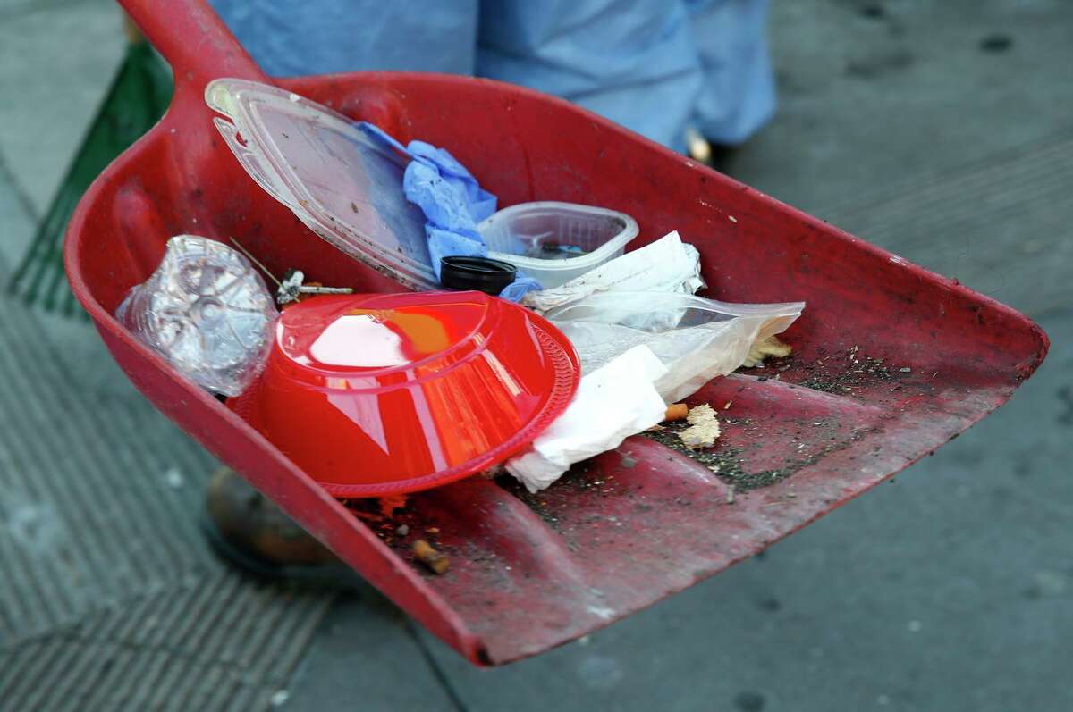 A San Francisco Public Works crew cleans trash in Mission District. Small-business owners have to do some dirty work.