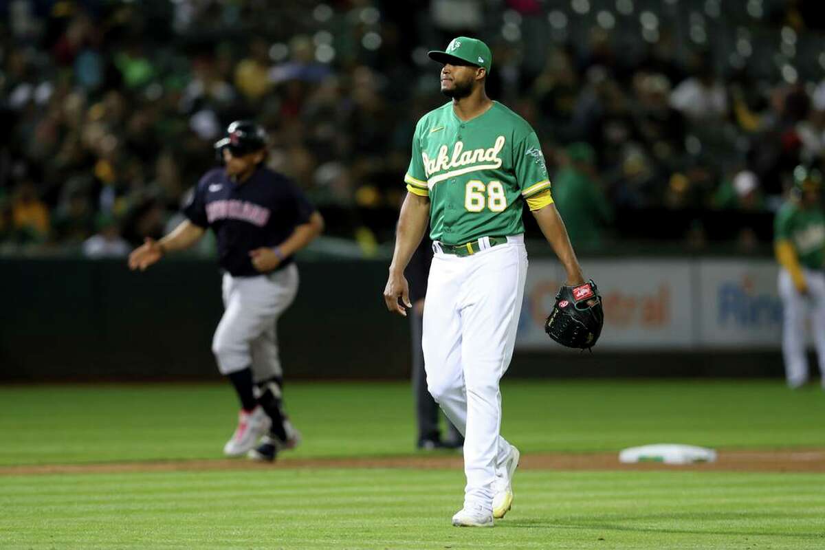 Cleveland Guardians' Josh Naylor, left, rounds the bases after hitting a two-run home off of Oakland Athletics' Domingo Acevedo (68) during the seventh inning of a baseball game in Oakland, Calif., Friday, April 29, 2022. (AP Photo/Jed Jacobsohn)