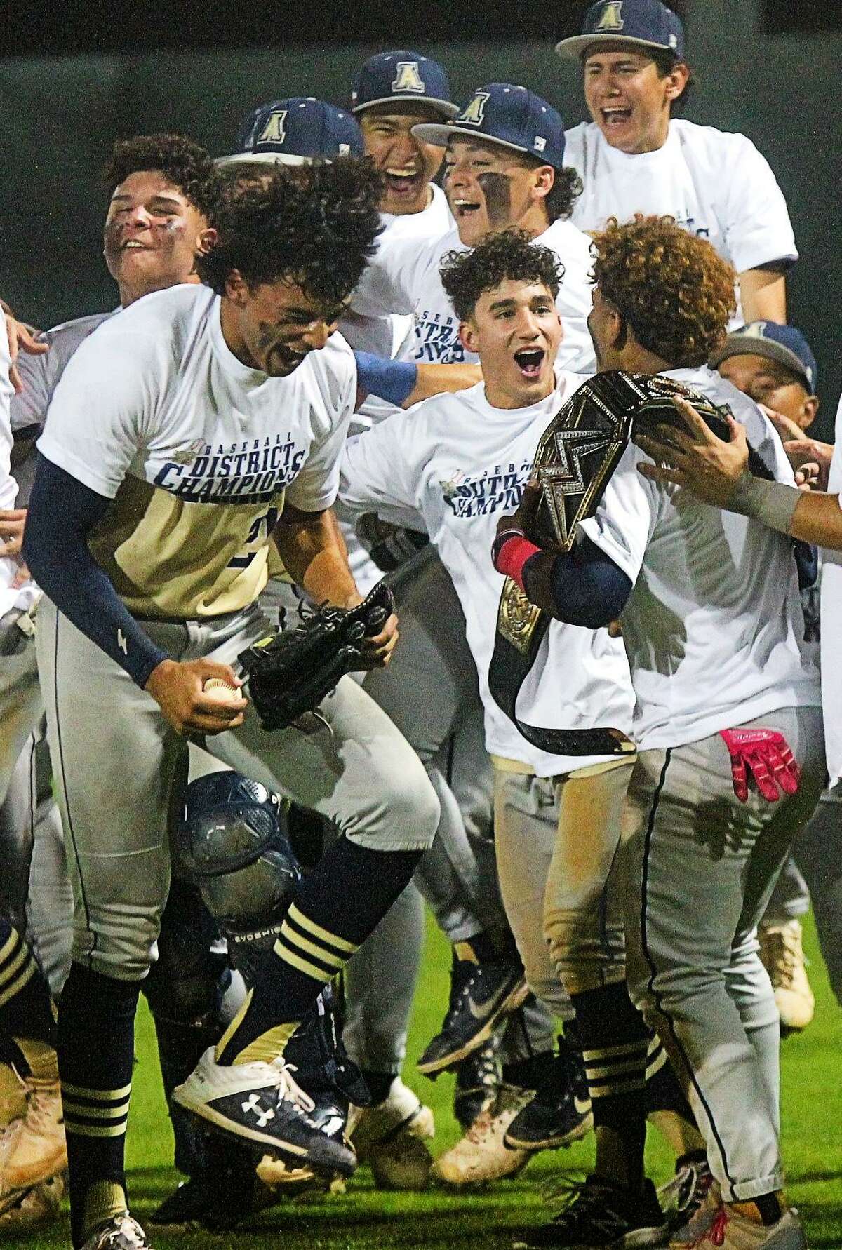 Marco Villanueva (with the belt) celebrates with his teammates following Alexander’s win over United.