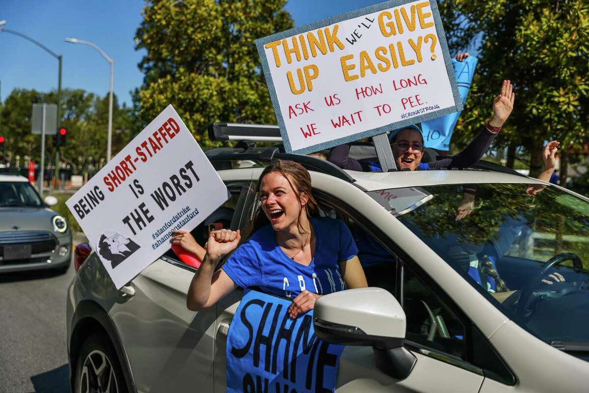 People participate in a rally as they drive by nurses on strike outside Lucile Packard Children’s Hospital in Palo Alto.
