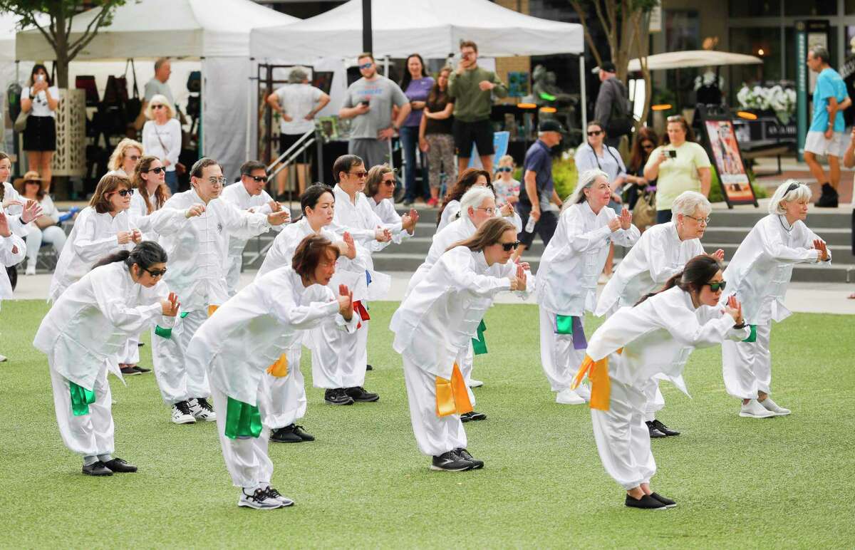 Members of Woodlands Tai Chi perform for visitors during the annual Spring Fine Arts Show at Market Street, Saturday, April 30, 2022, in Conroe. Families browsed various art booths, enjoyed live music, and participate in artist demonstrations.