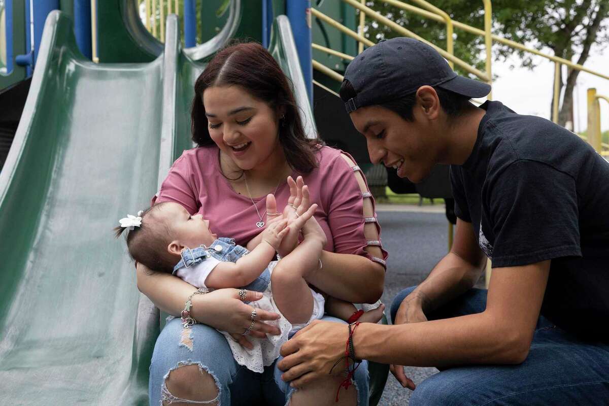 Parents Jaret Anchondo and Estefania Chapa play with their 5-month-old daughter, Rosali, in a park in Converse. Anchondo and Chapa have been having trouble finding their prescribed baby formula for Rosali, and they’ve spent hours driving around the city looking for it.