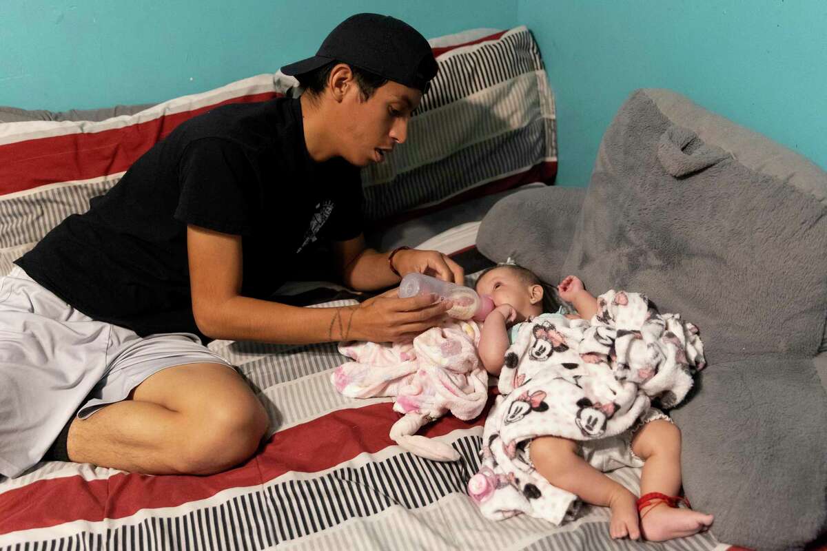 Jaret Anchondo holds a bottle for his 5-month-old daughter, Rosali. Anchondo and his partner, Estefania Chapa, have been having trouble finding their prescribed baby formula for Rosali, and they’ve spent hours driving around the city looking for it.