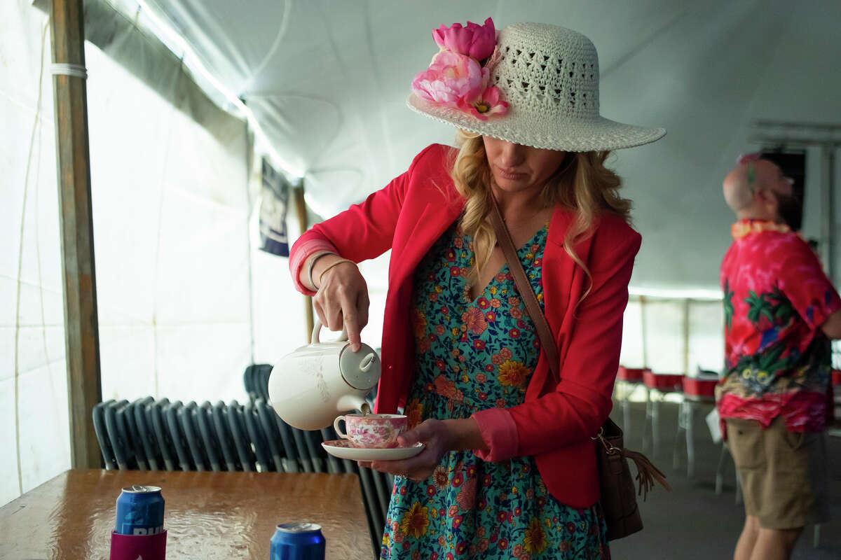 Emma Reynolds refreshes her drink before participating in the Freeland Walleye Festival Beer Pong Tournament Saturday, April 30, 2022 at Burt Watson Chevrolet in Freeland.