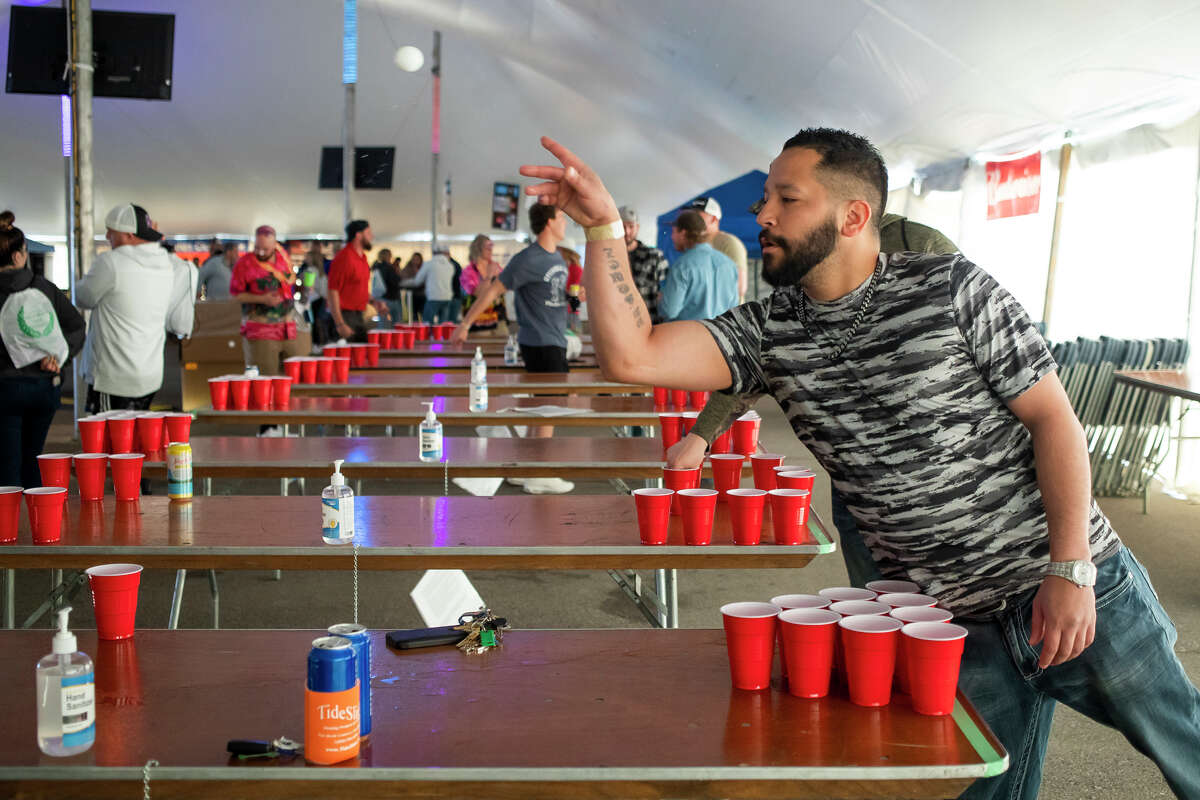 Jordan Vasquez warms up before participating in the Freeland Walleye Festival Beer Pong Tournament Saturday, April 30, 2022 at Burt Watson Chevrolet in Freeland.