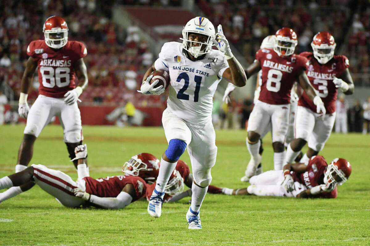 San Jose State running back DeJon Packer breaks through the Arkansas defense to score a touchdown during the second half of an NCAA college football game Saturday, Sept. 21, 2019, in Fayetteville, Ark.