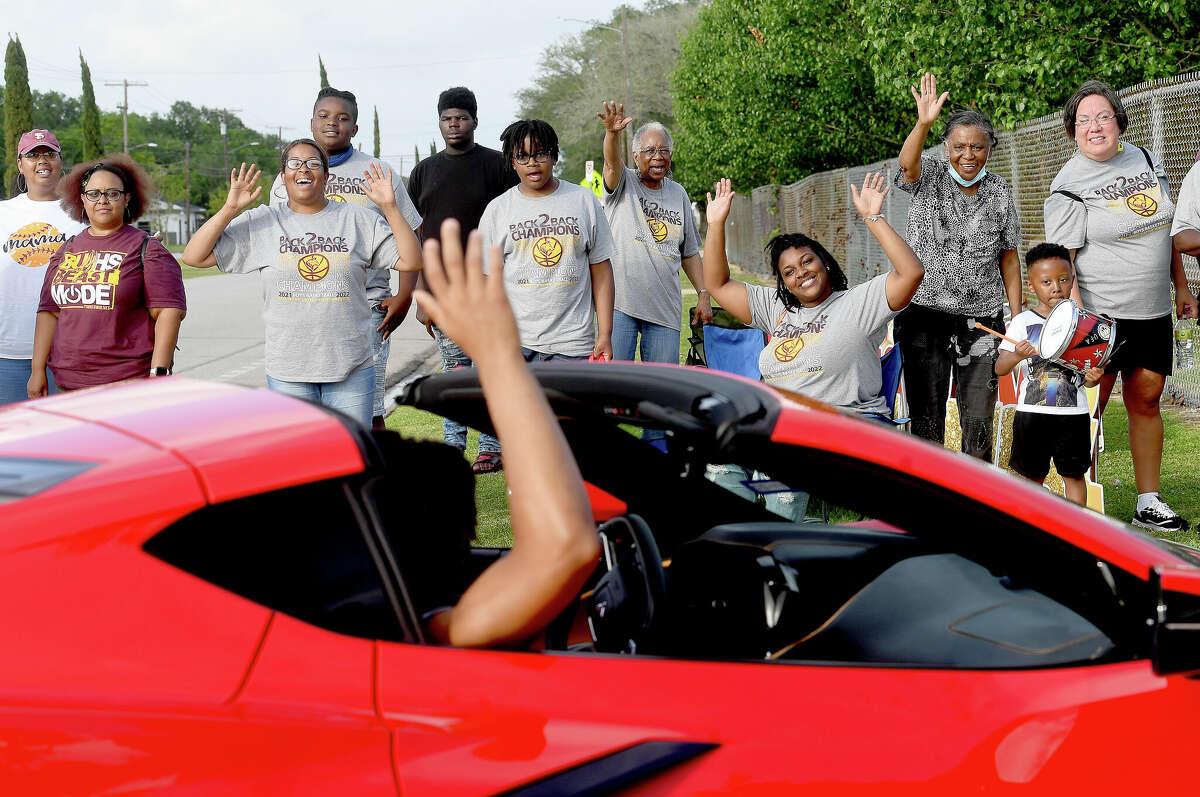 Fans cheer as Beaumont United players chauffeured in Corvettes make their way back to the school for a post-parade pep rally celebrating the Timberwolves' back to back state basketball champion title Saturday at the school. Photo made Saturday April 30, 2022. Kim Brent/The Enterprise