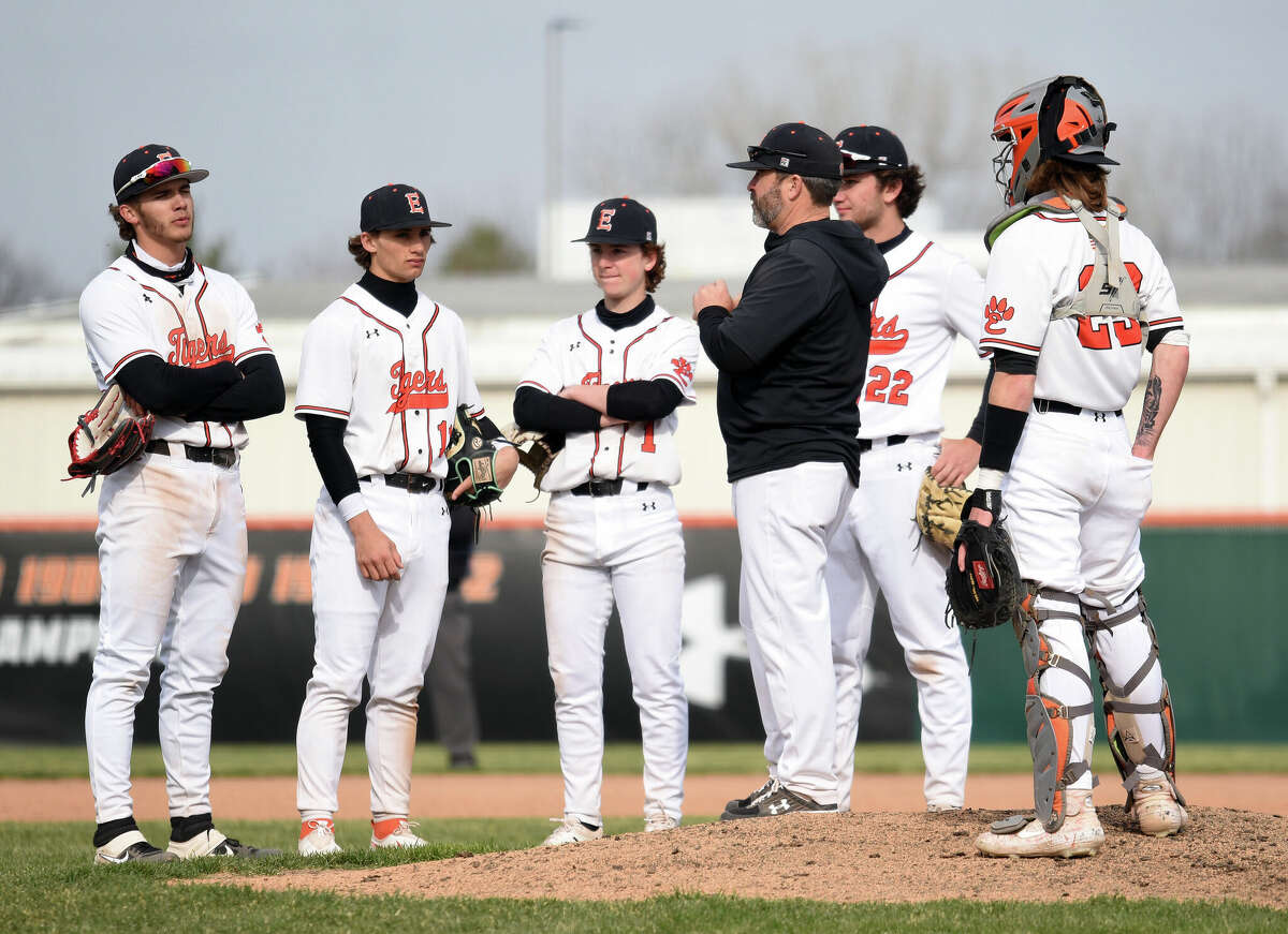 Edwardsville coach Tim Funkhouser stands with his infielders during a pitching change earlier this season at Tom Pile Field in Edwardsville.