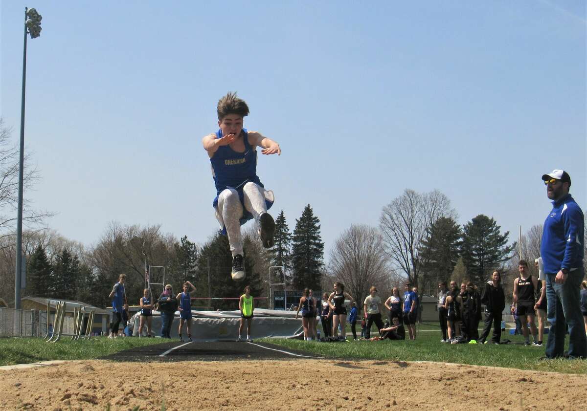 Onekama's Tucker Pratt attempts the long jump at the Onekama Invite on Friday, April 29 at Onekama High School
