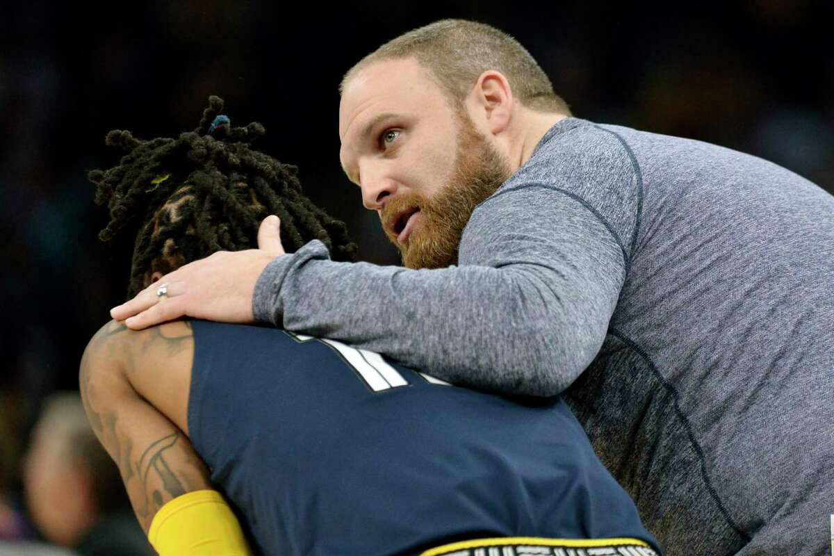 Memphis Grizzlies head coach Taylor Jenkins, right, talks with guard Ja Morant in the second half during Game 5 of a first-round NBA basketball playoff series between the Grizzlies and the Minnesota Timberwolves Tuesday, April 26, 2022, in Memphis, Tenn. (AP Photo/Brandon Dill)