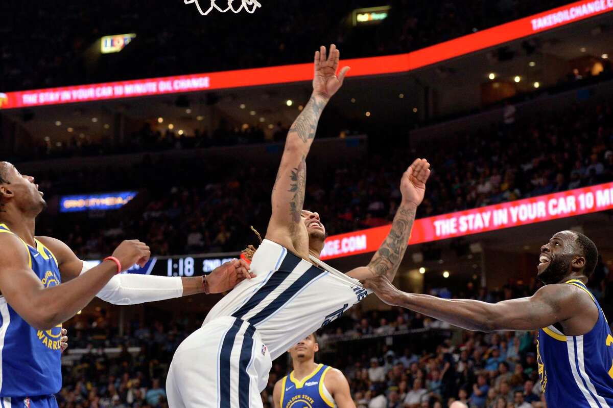 Golden State Warriors forward Draymond Green, right, fouls Memphis Grizzlies forward Brandon Clarke, resulting in Green being ejected, in the first half during Game 1 of a second-round NBA basketball playoff series Sunday, May 1, 2022, in Memphis, Tenn. (AP Photo/Brandon Dill)