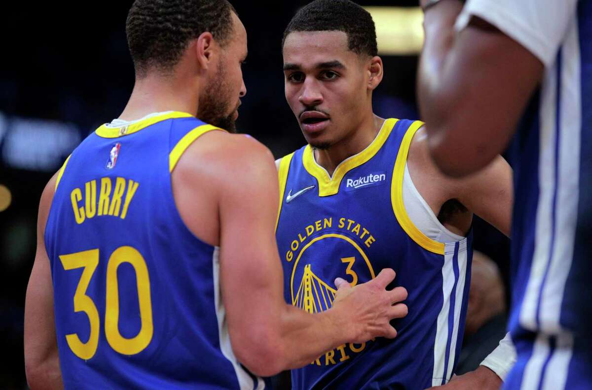 Stephen Curry (30) talks with Jordan Poole (3) duirng a timeout in the second half as the Golden State Warriors played the Memphis Grizzlies in Game 1 of the second round of the NBA Playoffs at Fedex Forum in Memphis, Tenn., on Sunday, May 1, 2022.