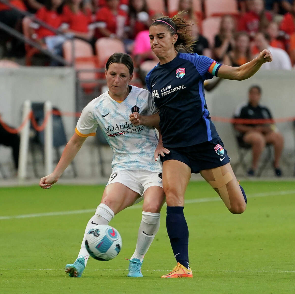 Houston Dash Haley Hanson, left, is pressured by San Diego Wave Alex Morgan during the second half of game at PNC Park Sunday, May 1, 2022, in Houston.